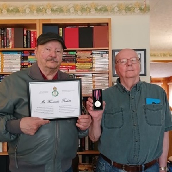 Image: Ronald (l) and Brian Fredette accepting on behalf of Veteran 
				Hormidas Fredette